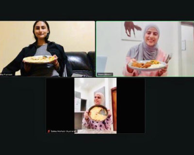 Image of 3 people from a zoom call smiling and holding up their home-made meal